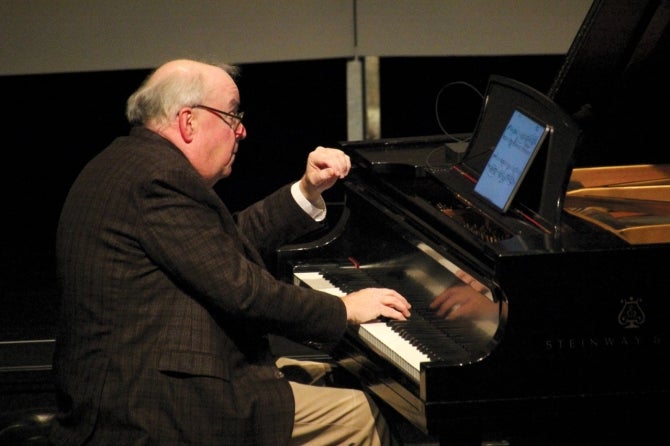 Pianist and music Professor Emeritus W. Terrence Spiller performs on the piano