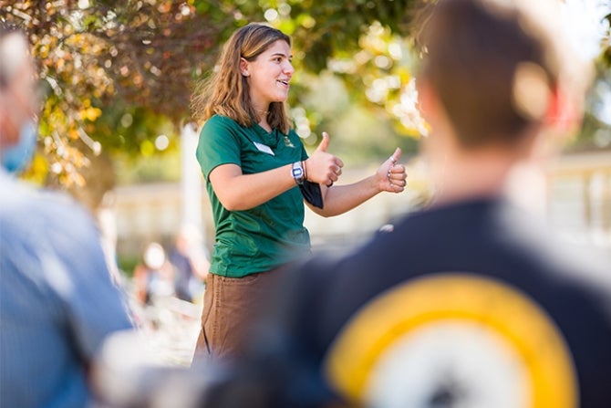 A Poly Rep student leader gives thumbs up during a campus tour