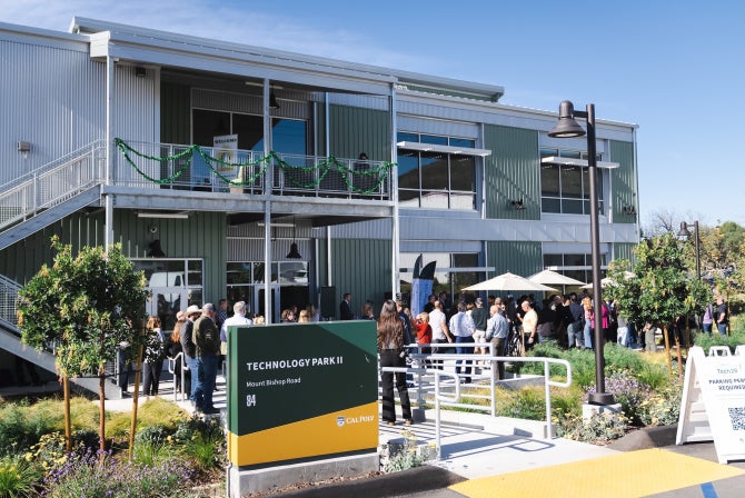 Attendees celebrate at the ribbon cutting for the opening of the second phase of the Tech Park on Mount Bishop Road
