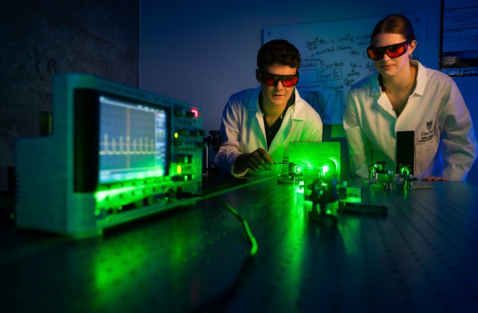 hysics students James Mauck and Hannah Bauer align a green light pump laser used as part of a project to build Cal Poly’s first laser