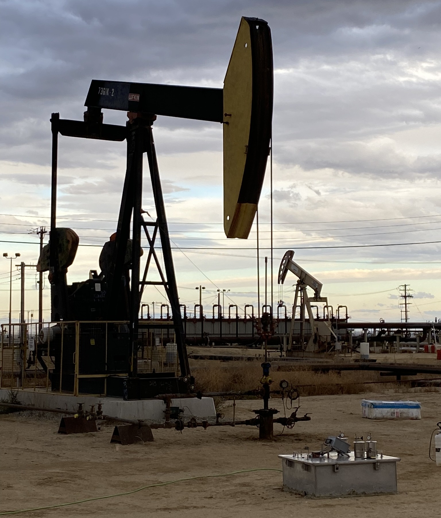 Plugged and abandoned oil wells near active oil pumps at the Aera Energy South Belridge site