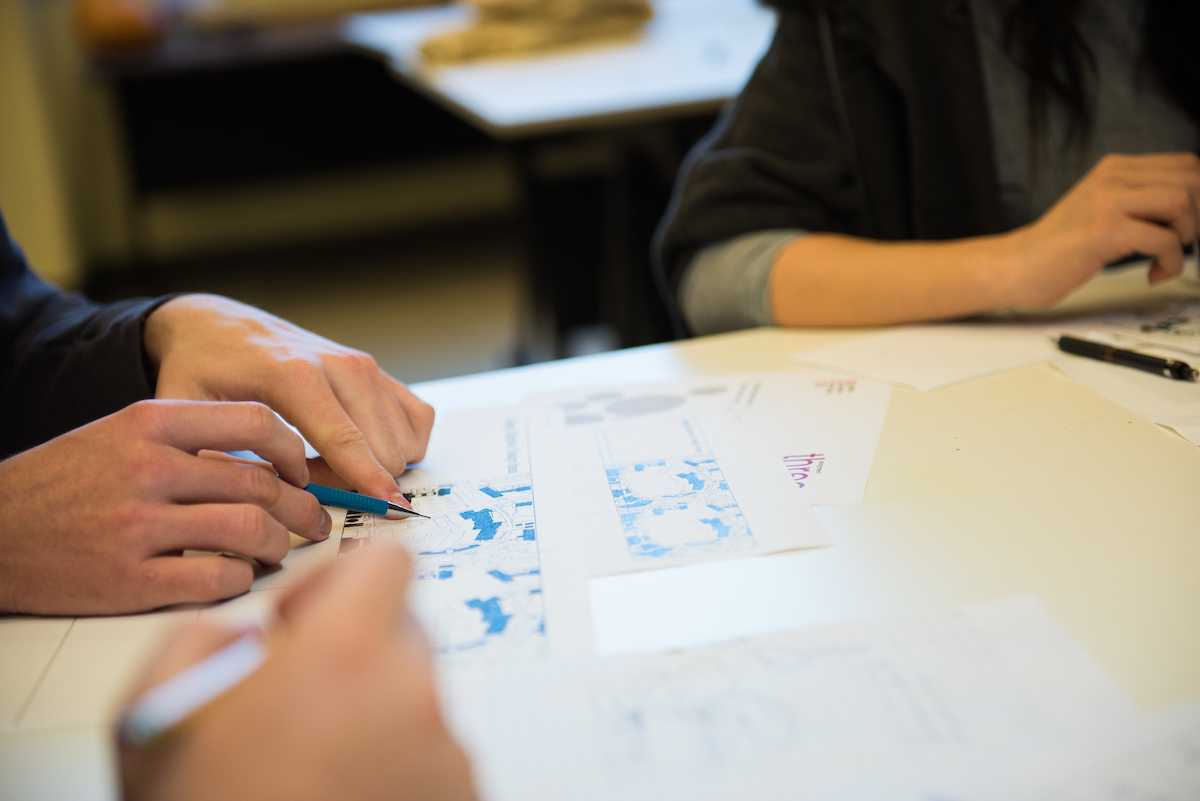 Cal Poly students reviewing analytical information and charts