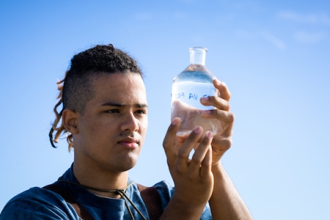 Jake Roth, a fourth-year student from Bellevue, Washington, examines sea water through a clear glass container