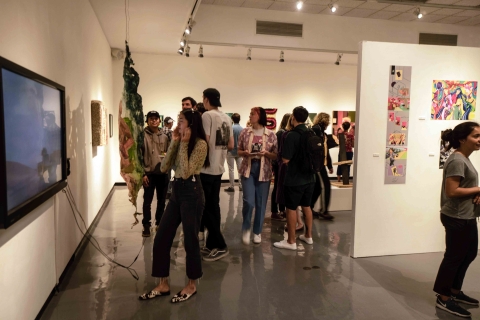 Students and art fans gather on opening night at the campus art gallery in 2019