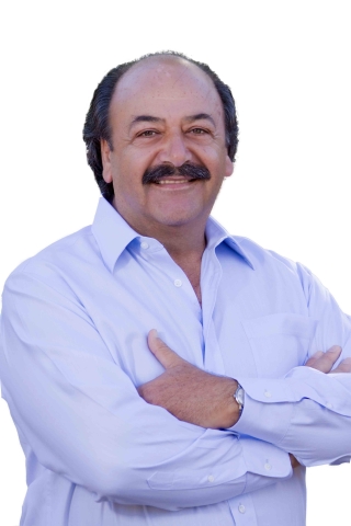 A portrait of former Assemblyman Katcho Achadjian wearing an open collar long-sleeve shirt