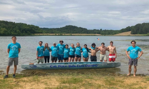 Cal Poly concrete canoe team pose with canoe Oceana at Blackhawk Lake in Wisconsin where the races were held
