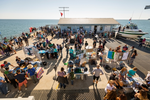 Marine displays set up on the Cal Poly Pier are visited by Open House attendees in 2019