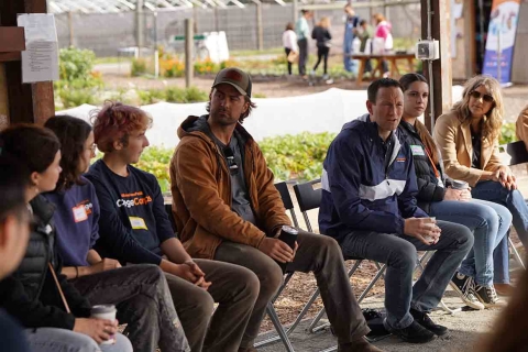 Students participate in a outdoor roundtable discussion