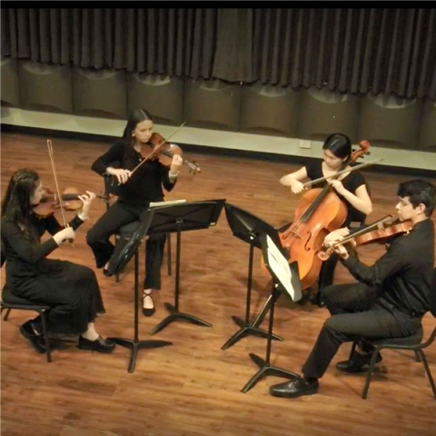 A student string quartet performs on stage