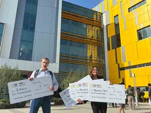 William Burns of the startup ENTEIN and Penny Lane Case of Nexstera Tech hold massive checks totalling $28000 at the CSU Startup Launch Competition