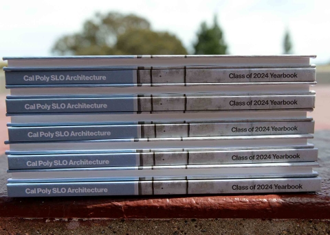 A stack of yearbooks showing the bookspines and title: Cal Poly SLO Architecture Class of 2024