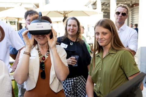 People wait to watch a demonstration of the ODIN Diagnostics headset designed to detect concussions