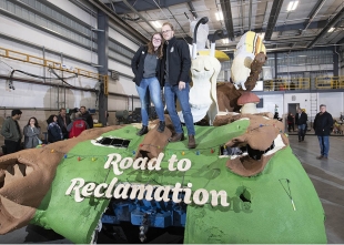 Rose Float team presidents Annie Doody of Cal Poly San Luis Obispo and the Ryan Ward of Cal Poly Pomona pose atop the float