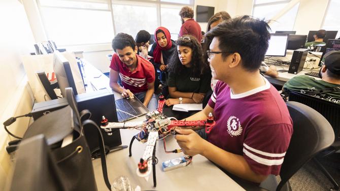 Students work together to build a drone