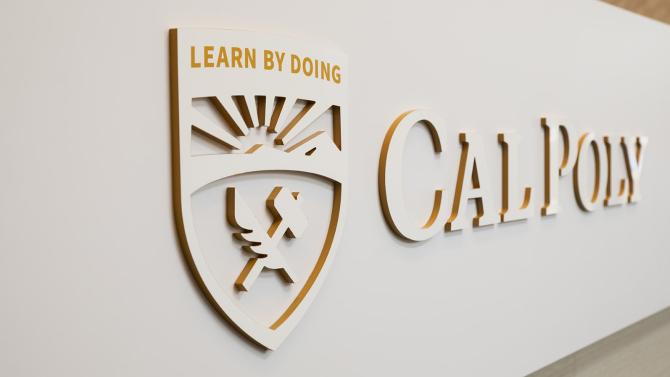 Cal Poly logo in wood along the Welcome Center desk