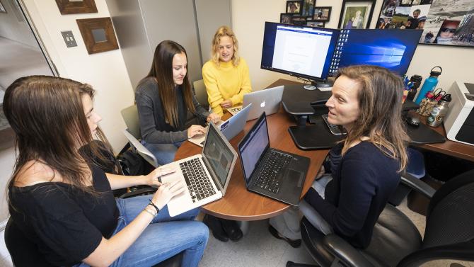 Collaboration in action as a professor works with a group of students