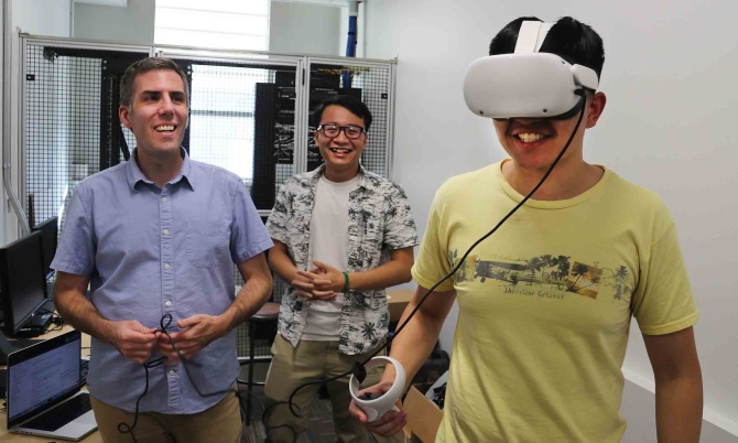 Professor Jonathan Ventura and two students test a 3D video produced with the help of artificial intelligence