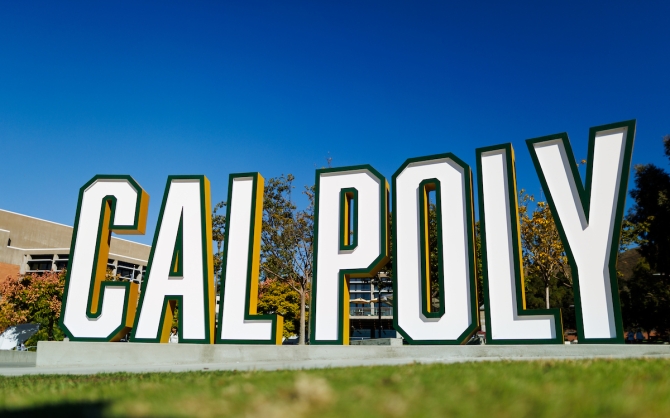 A free-standing sign spells our Cal Poly in large letters near the University Union